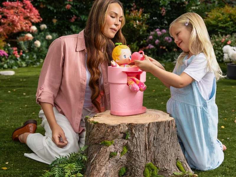Mother and daughter playing with a pink Luvibubs Doll toy.