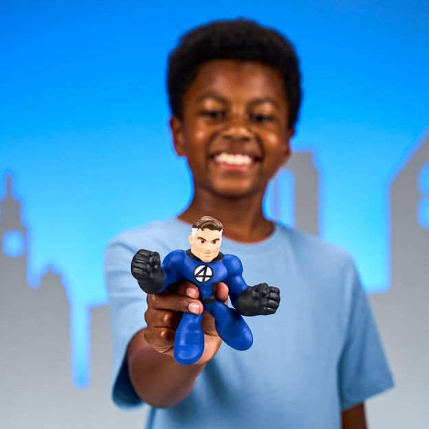 Young boy holding a Marvel Mister Fantastic Goo Jitzu toy. 