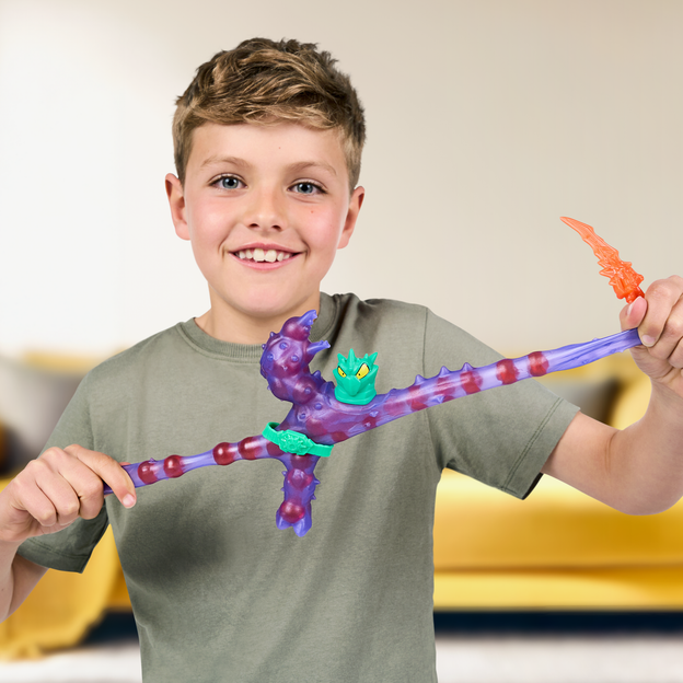 Young boy stretching a purple Heroes of Goo Jit Zu toy by its arm and leg.