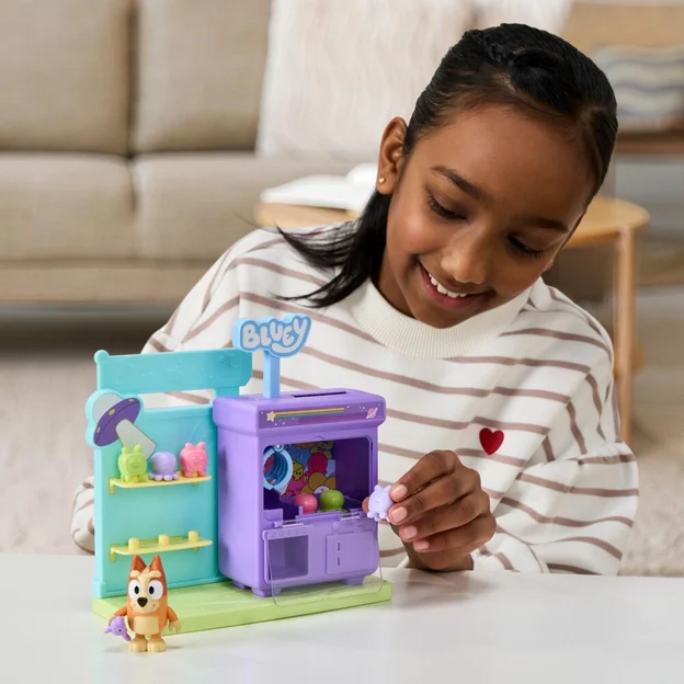 Young girl playing with her Bluey Mini Playset Claw Machine.