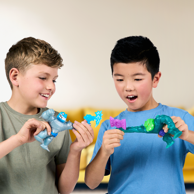 Two young boys battling with their Heroes of Goo Jit Zu action figure toys. 