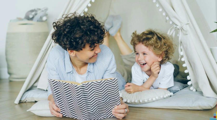 Madre contándole a su pequeño hijo fábulas en inglés
