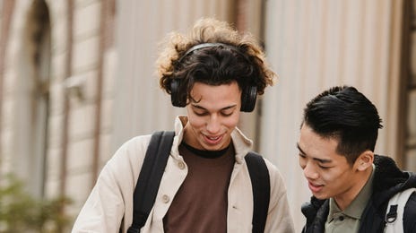 Dos estudiantes charlando mientras revisan las actividades del curso de idioma.